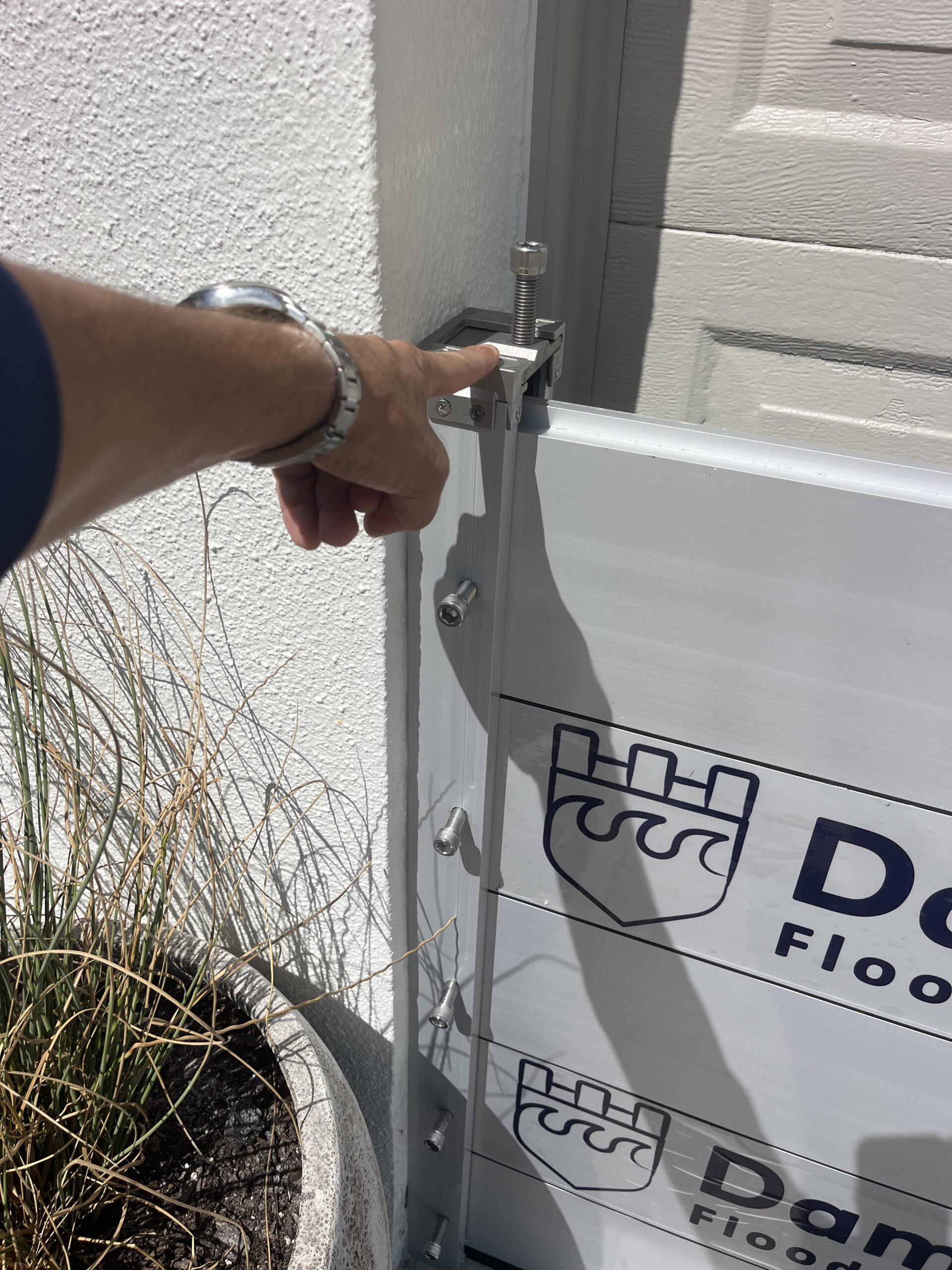 Technician tightening gasket hardware on Dam It Defense flood panel